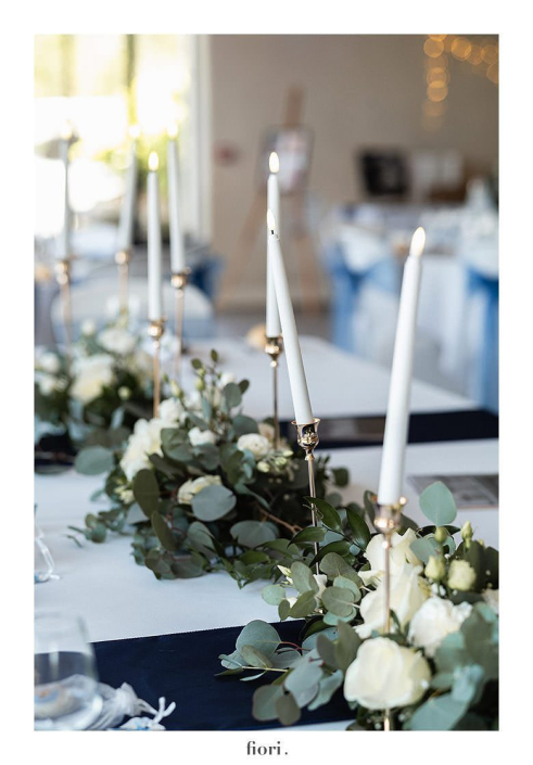 Centre de table eucalyptus et chandeliers Centre de table de mariage en eucalyptus et roses blanches avec chandeliers et bougies blanches